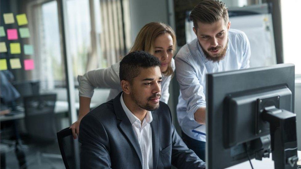 Colleagues working in office