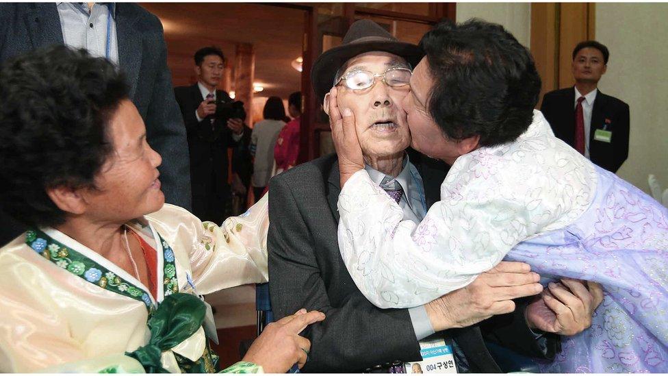 North Korean Ku Song Ok, 71 (right) kisses her South Korean father Gu Sang-yeon, 98, as her North Korean sister Ku Sun Ok, 66 (left) smiles after the Separated Family Reunion Meeting at the Diamond Mountain resort in North Korea, 26 October 2015