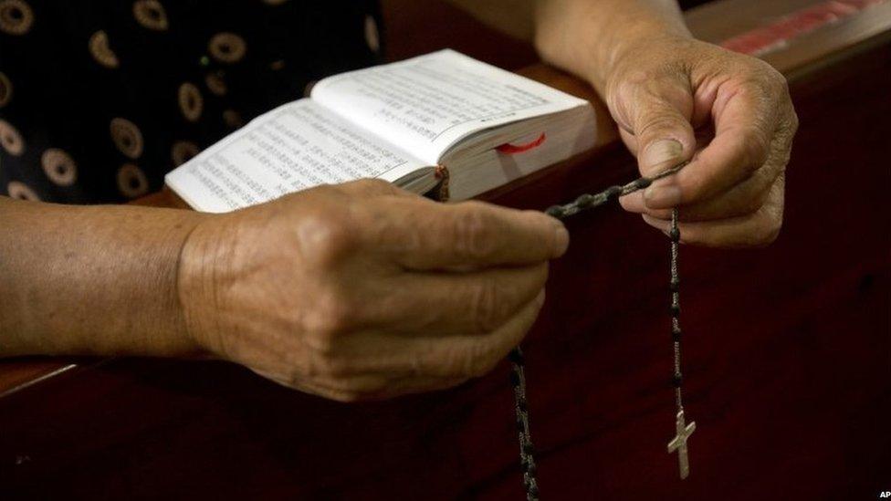 A Christian woman reads a bible at a church in Zhejiang, China (30 July 2015)