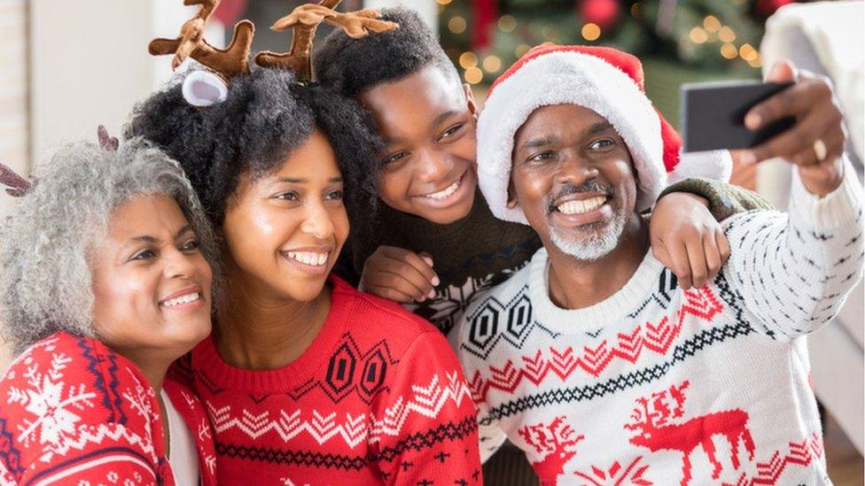 Family wearing christmas jumpers