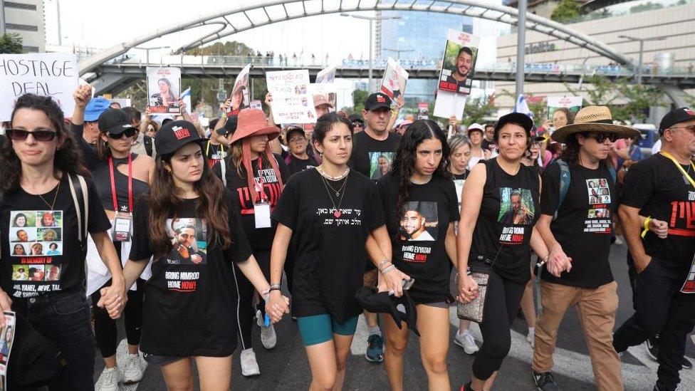 Families of Israeli hostages held by Hamas in Gaza march during a rally, in Tel Aviv