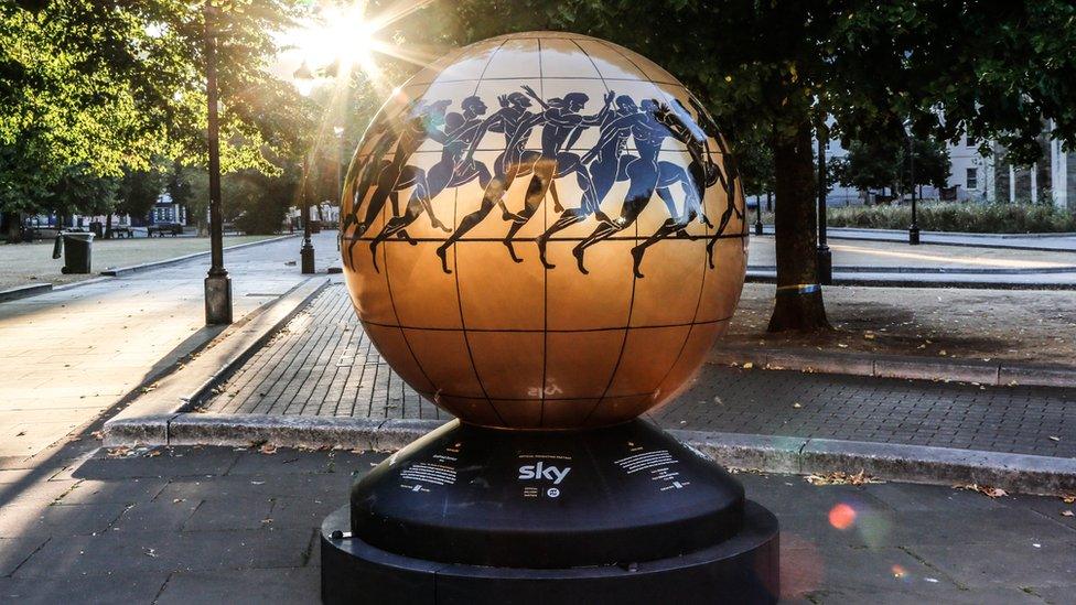 Gold globe with African tribal artwork