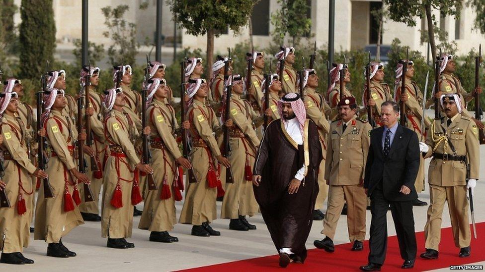 Jordan's Prince Faisal bin Al-Hussein (front R), and Saudi Arabia's Deputy Crown Prince Mohammed Bin Salman (front L) review Bedouin honour guards at the Royal Palace in Amman on 4 August 2015