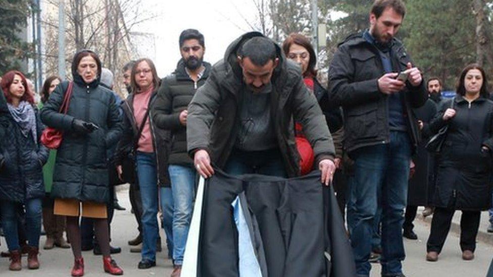 Academics lay down their gowns during a protest outside a university campus in Ankara (10 February 2017)