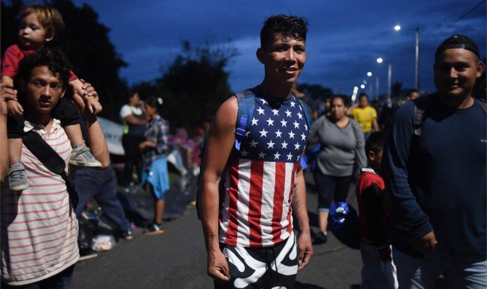 A young Honduran migrant wearing an American flag t-shirt