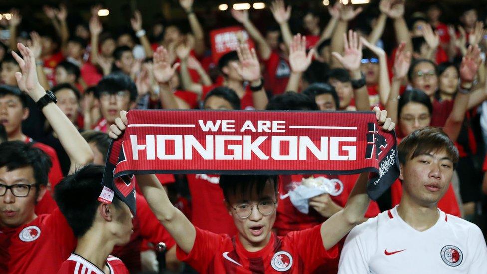 Soccer fans demonstrate inside Hong Kong Stadium