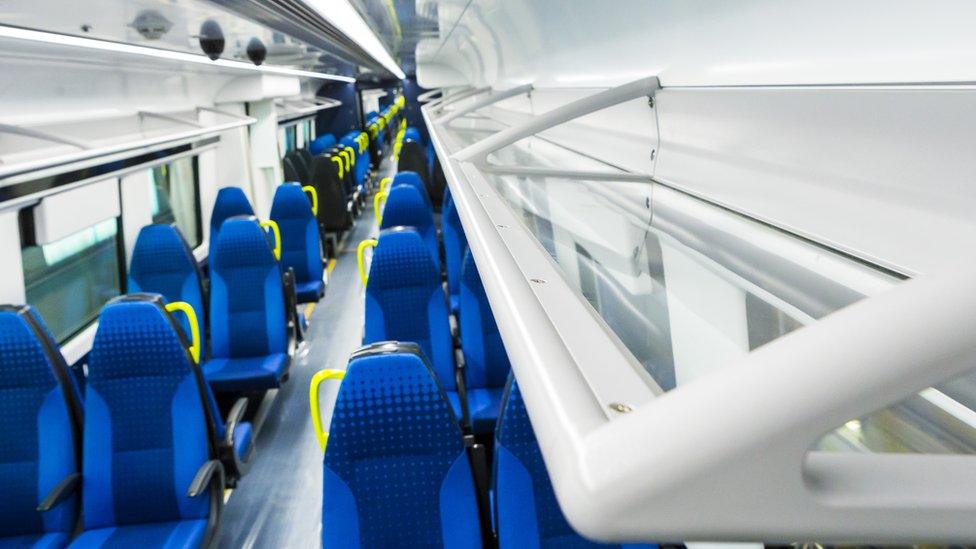 Inside the new train showing luggage storage