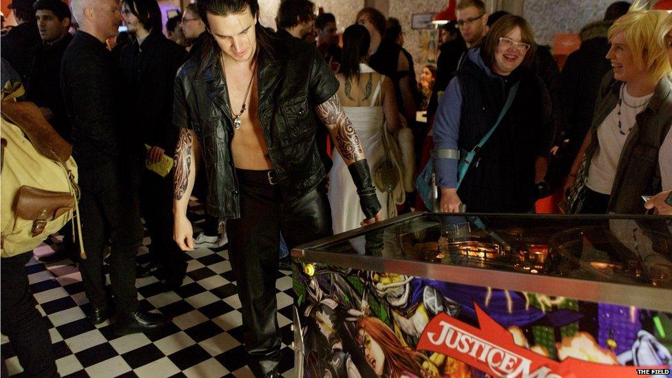 An actor playing the arcade game Justice Monsters 5