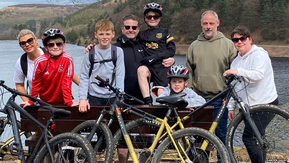 Damien Gaunt, second from right, with his children, partner and his friend's family