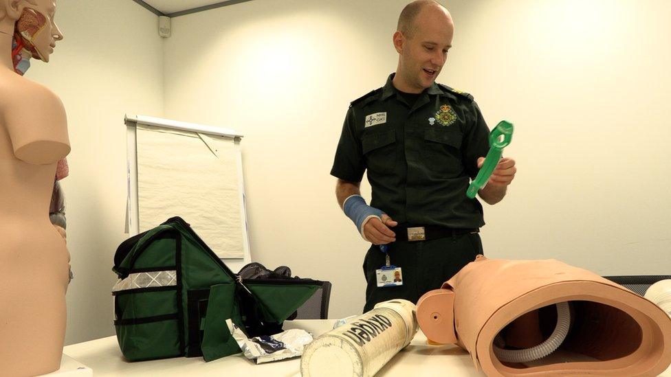 Man looking at dummy