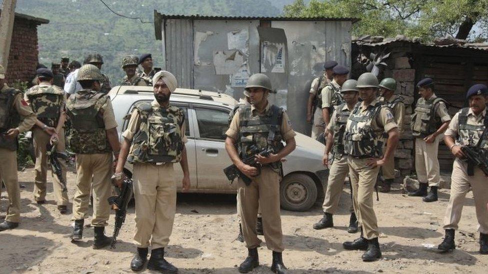 Indian paramilitary soldiers stand after a gunbattle on the Jammu- Srinagar highway at Narsoo Nallah, near Udhampur, India, Wednesday, Aug. 5, 2015