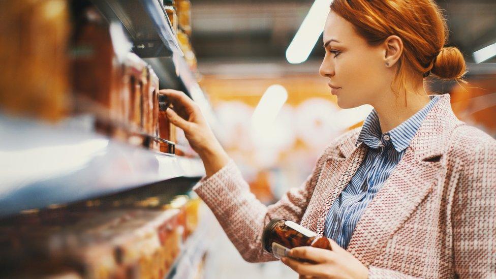 Woman searching for different product in shop