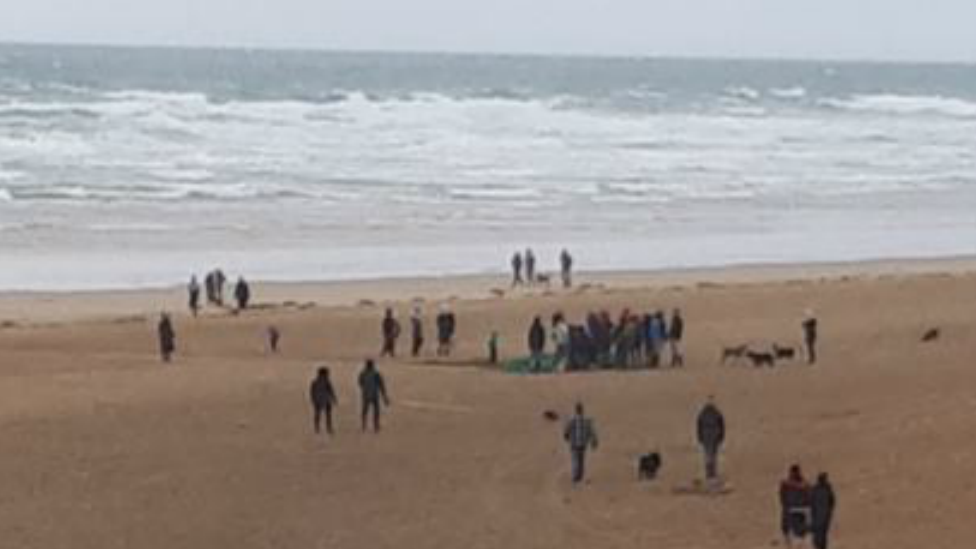 ghost net being dragged up a beach