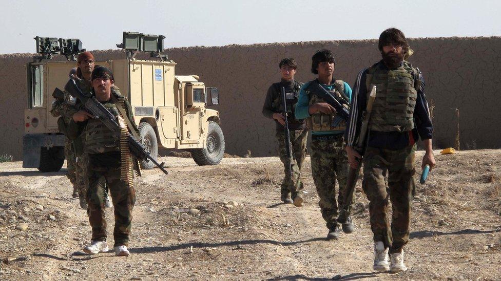 Afghan National Army (ANA) soldiers walk in Helmand on December 21, 2015.