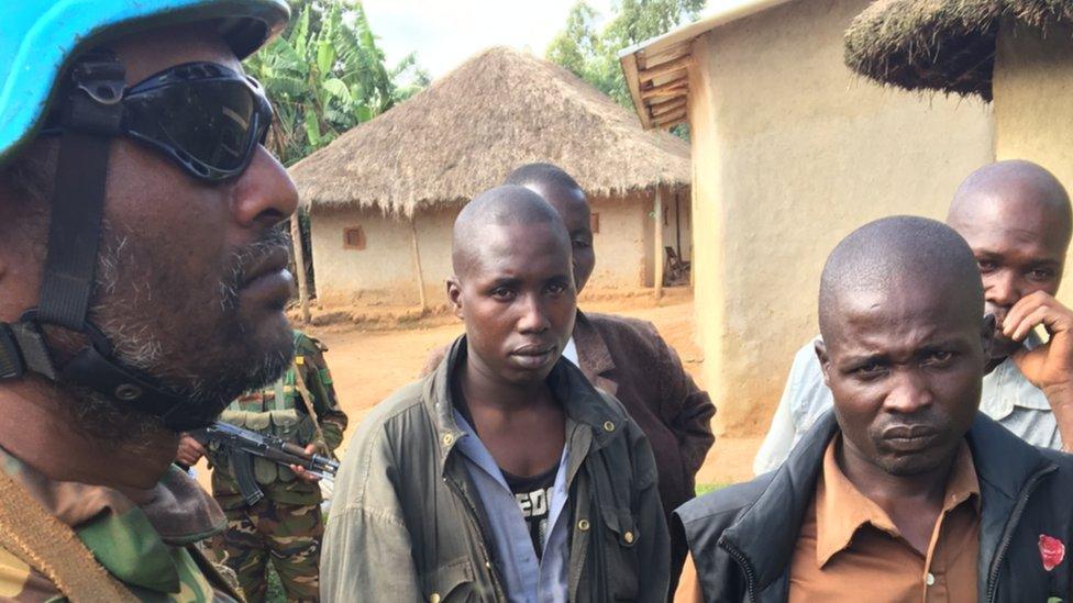 A soldier with survivors in DR Congo