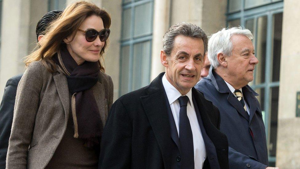 Carla Bruni-Sarkozy, French former President Nicolas Sarkozy and 16th arrondissement Mayor Claude Goasguen arrive at the Lycee Lafontaine to vote for the French Regional Elections first round in Paris