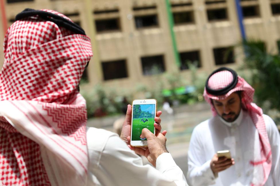 Men searching for Pokemon characters in Saudi Arabia