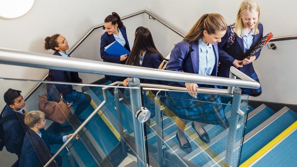 Children going up a staircase to go back to school