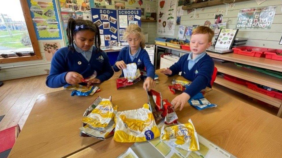 children sorting crisp packets