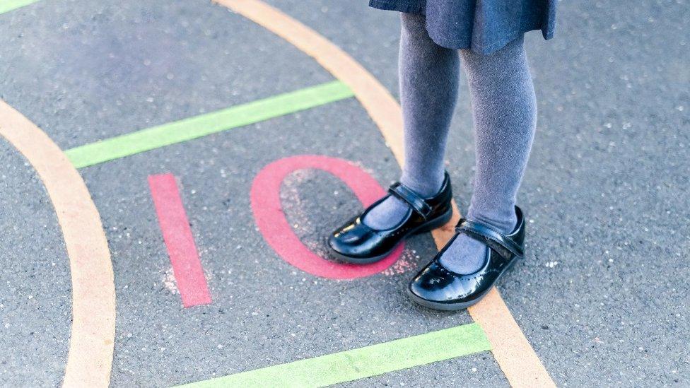 A little girl playing in the school yard - stock photo