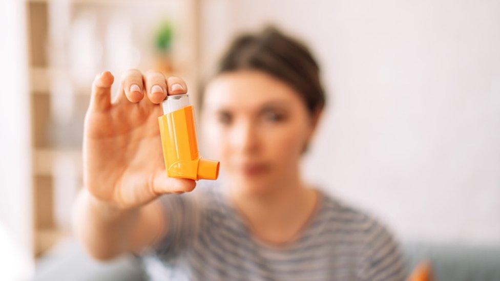 Woman holding inhaler