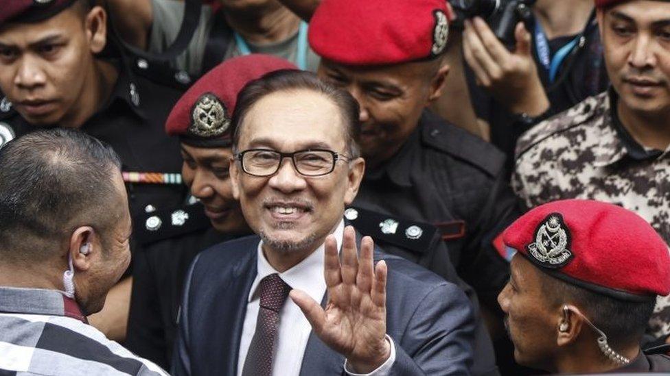 Malaysian former opposition leader Anwar Ibrahim (C) waves as he is escorted to his house by prison officers in Kuala Lumpur, Malaysia, 16 May 2018.