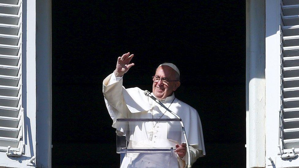 Pope Francis waves to pilgrims and tourists gathered in St Peter's Square in Vatican City on 1 November 2015