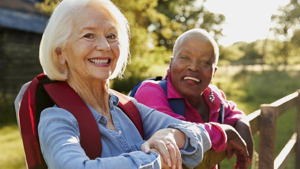 Two older women hiking in countryside