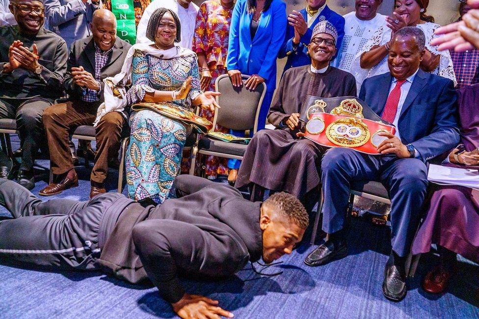 Anthony Joshua prostrating before Muhammadu Buhari