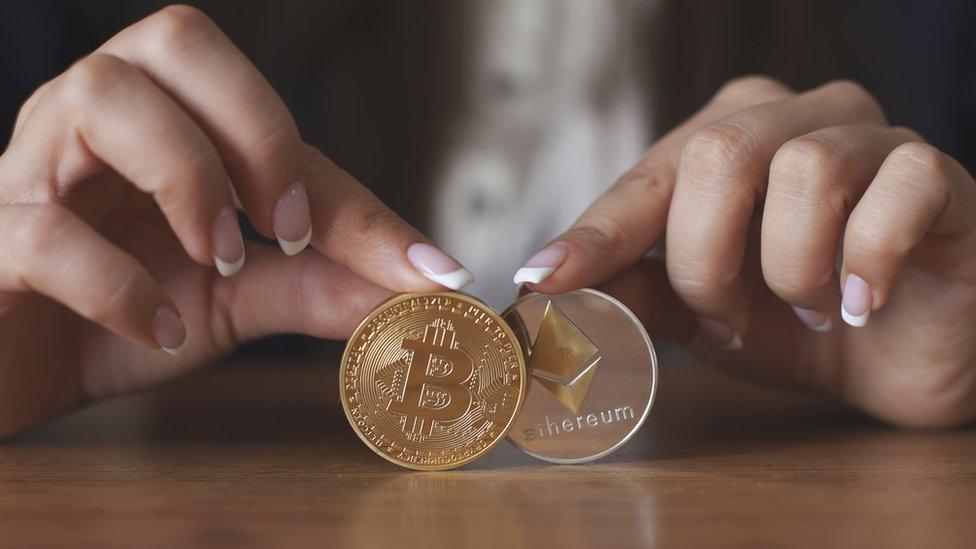 Woman holding Bitcoin and ethereum coins