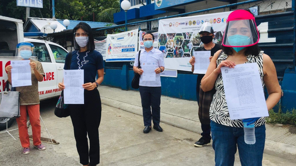 Activists on 'wanted' poster holding up the police reports they filed