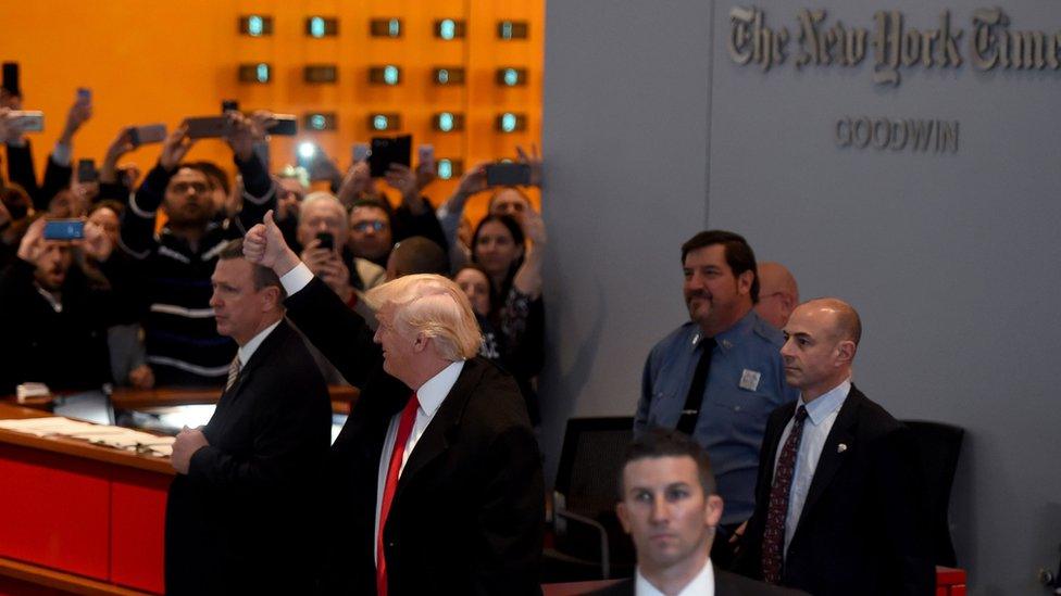 Trump with a thumbs-up sign in the New York Times building