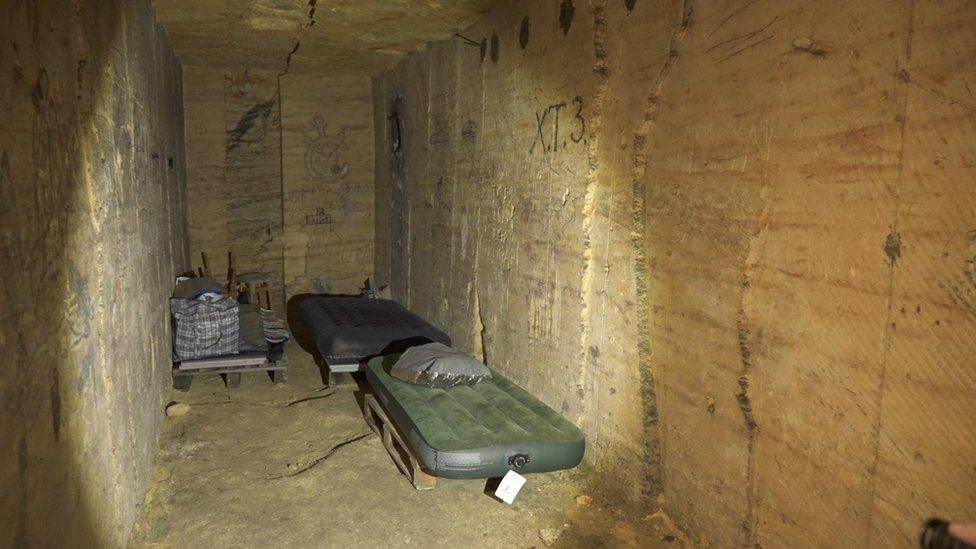 Picture showing mattresses lining the walls of the city's catacombs