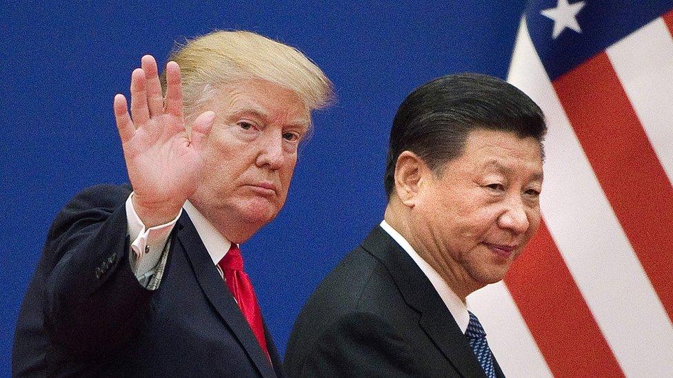 This file picture taken on November 9, 2017, shows US President Donald Trump (L) and China"s President Xi Jinping leaving a business leaders event at the Great Hall of the People in Beijing