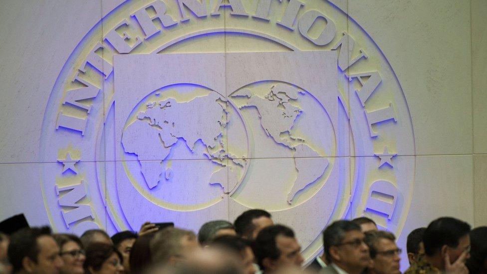 People watch as International Monetary Fund (IMF) managing director, Christine Lagarde speaks during opening remarks for the upcoming 2018 General IMF Meetings in Washington DC on October 1, 2018.