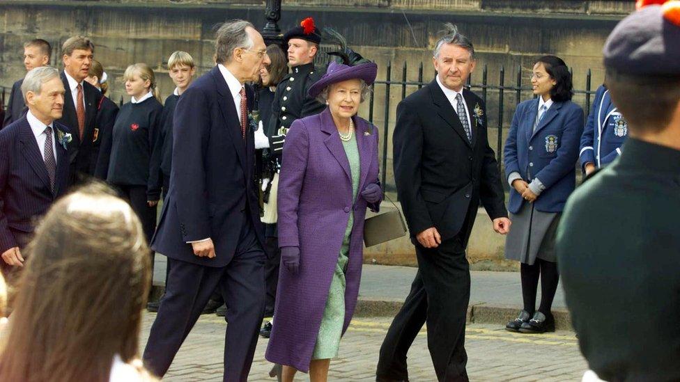 Britain's Queen Elizabeth 11 arrives to open the new Scottish Parliament in Edinburgh, 01 July 1999, with Scottish First Minister Donald Dewar (L), and the presiding officer David Steel (R).