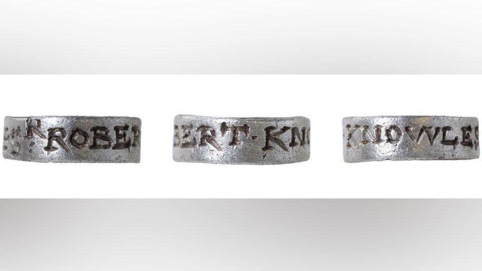 Three views of a silver hawking tag or vervel. It is engraved around its outside. The view on the left is engraved with the letters ROBER, the view in the middle has the letters BERT.KN and the view on the right has the letters KNOWLES.