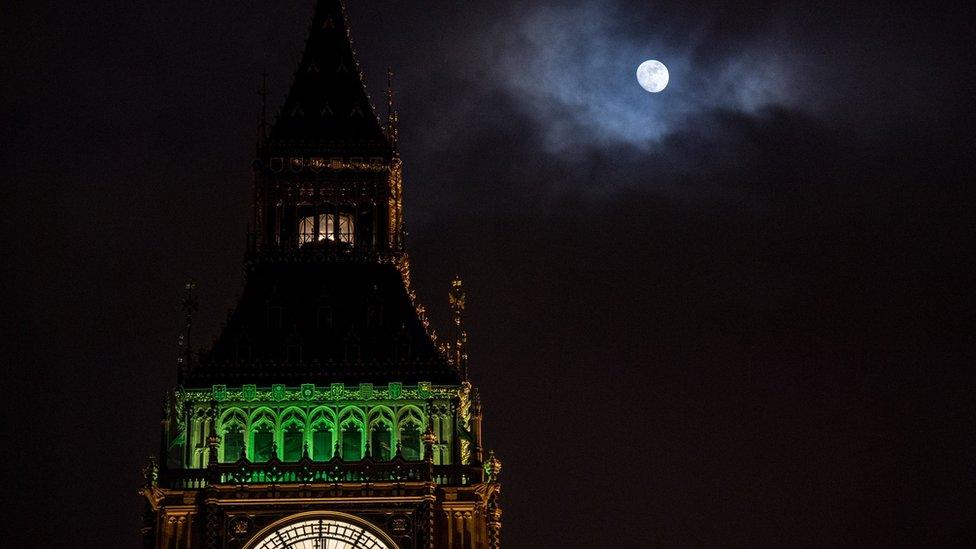 The Ayrton light shining at the top of Elizabeth Tower