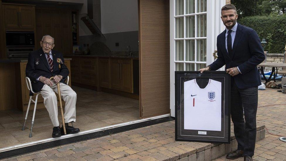 Captain Tom accepts a special England Shirt from David Beckham