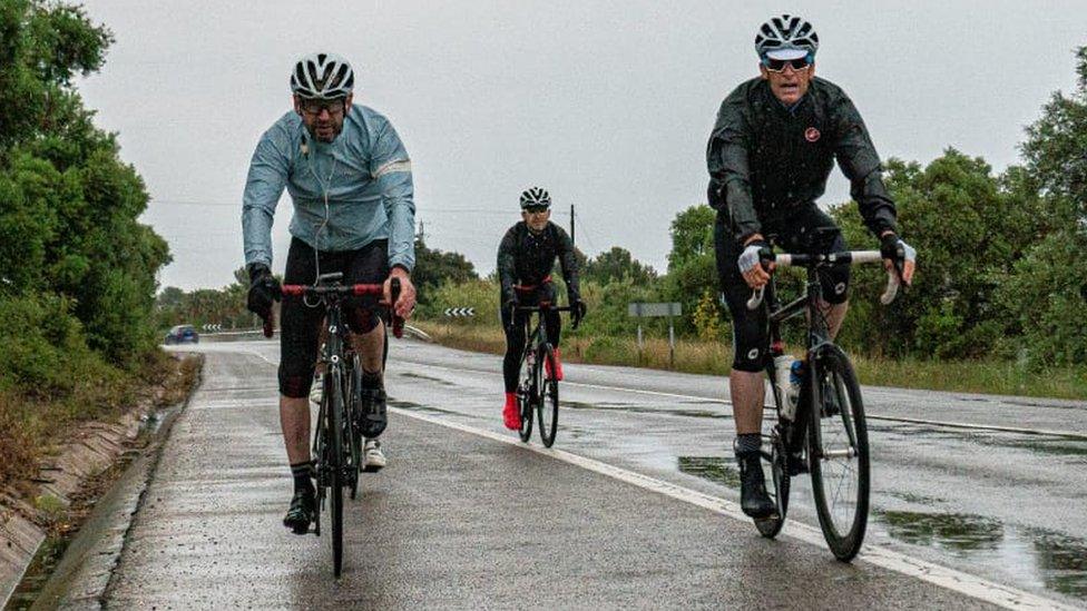 Cyclists riding on a wet road