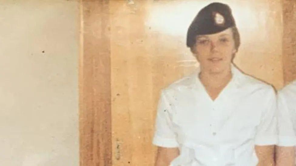 Photo from late 1970s/early 1980s of Pte Carol Morgan in a white shirt and Army beret