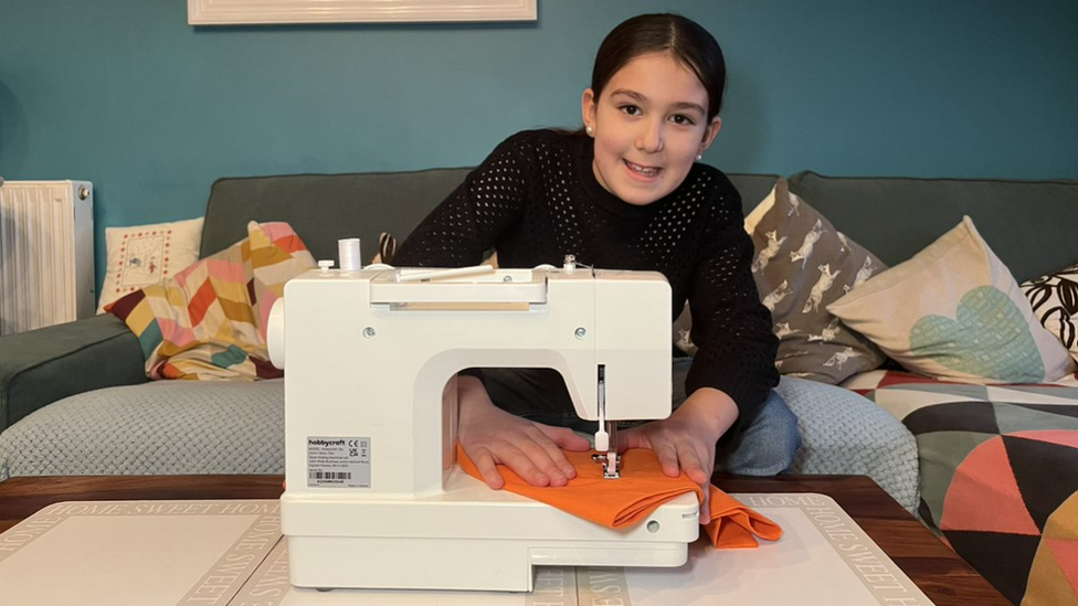 Andre sewing some clothes