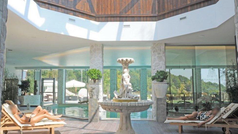 A Greek-inspired fountain urn, centre, is flanked by sun loungers in the spa's airy atrium