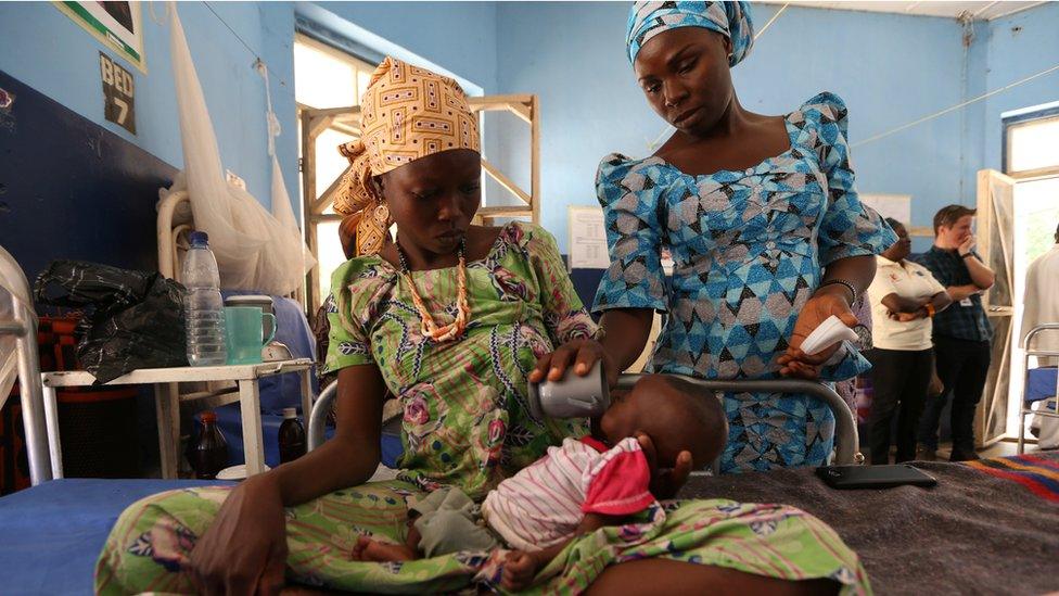 A nutritionist feeds a malnourished baby at the Molai General Hospital Maiduguri, Nigeria. November 30, 2016.