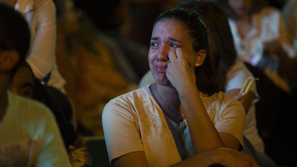 A woman cries on the steps to the Brumadinho Matriz church during a church service in honour of the missing people near the city of Brumadinho in the state of Minas Gerais, south-eastern Brazil, on January 31, 2019