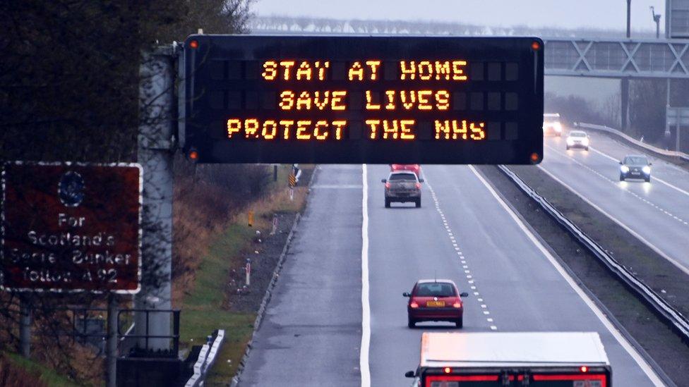 motorway sign saying 'stay at home save lives protect the nhs'