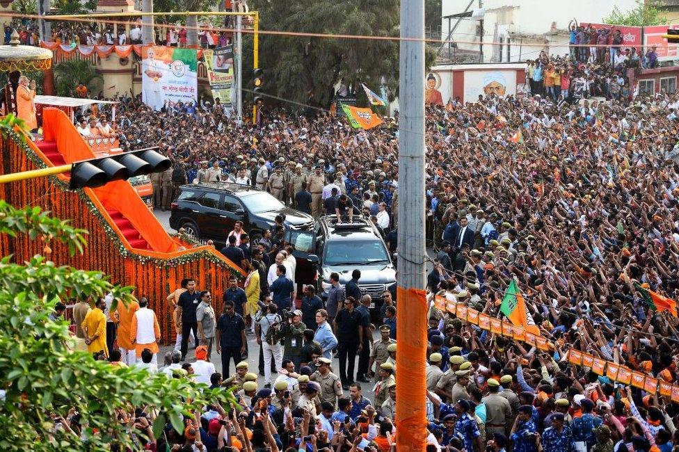 Mr Modi (left) gestures to the crowd of political supporters during a roadshow in Varanasi on April 25, 2019.