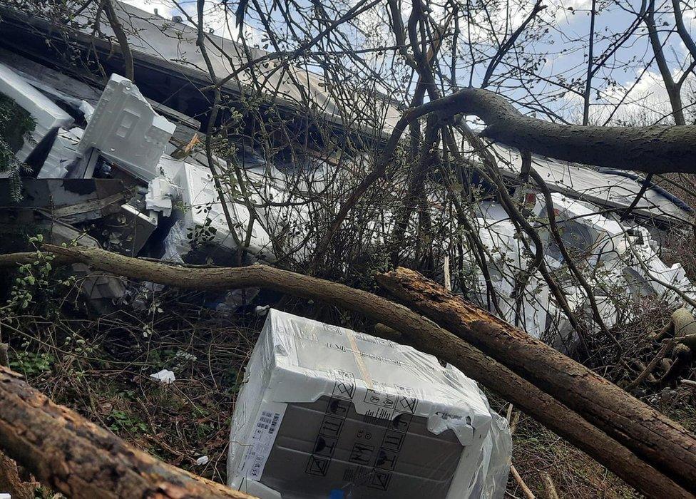 An overturned lorry and its goods