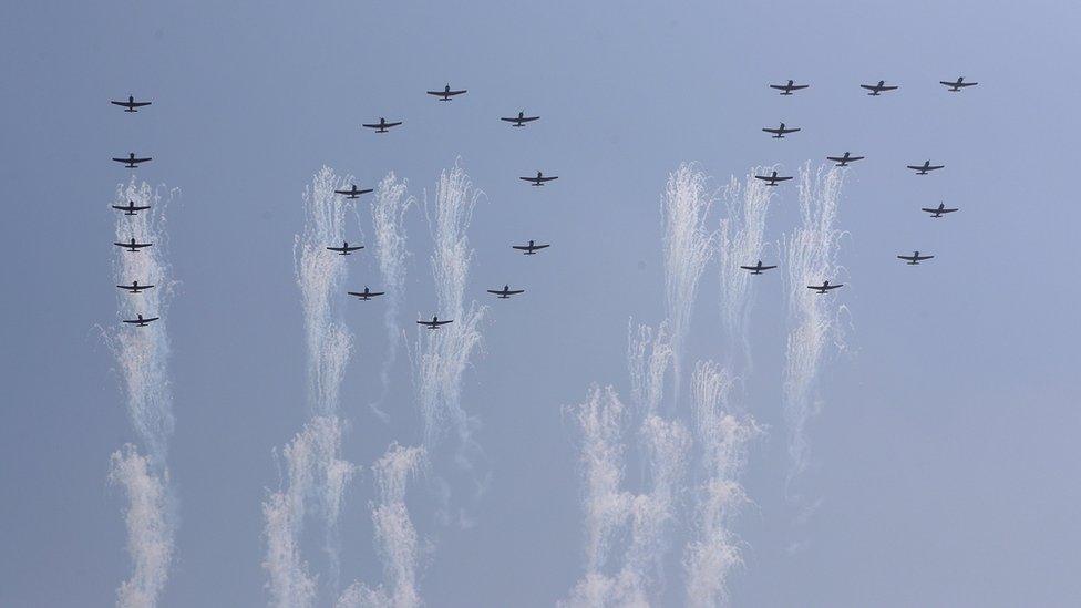 A formation of planes created the figures of 105 overhead