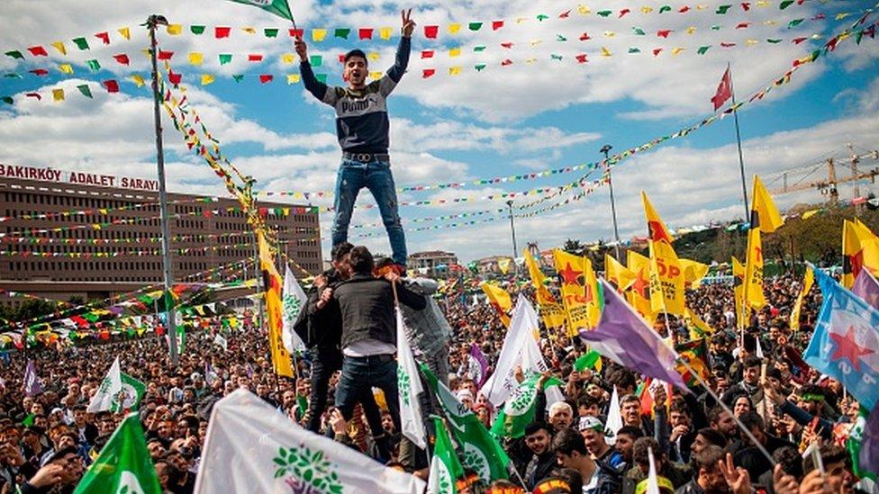 Supporters of Turkey's main pro-Kurdish HDP party cheer as they celebrate the Kurdish New Year during a campaign rally in Istanbul on March 2019